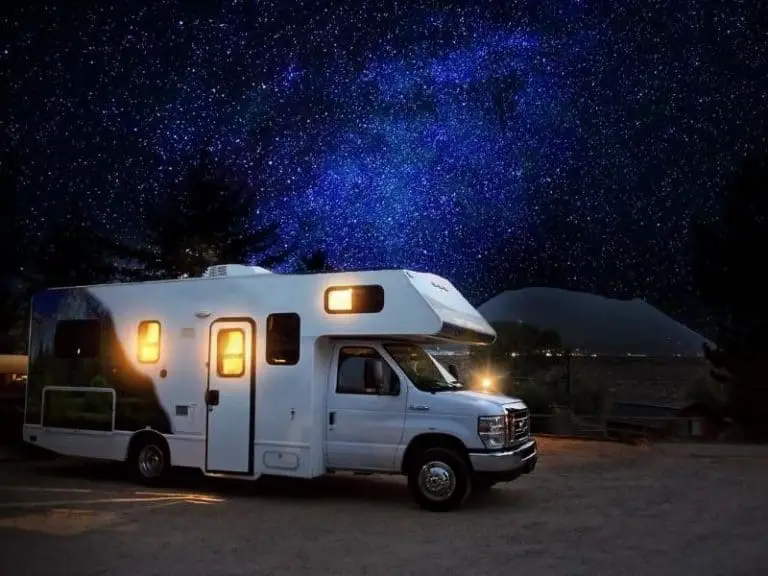 RV parked at night in a starlit sky