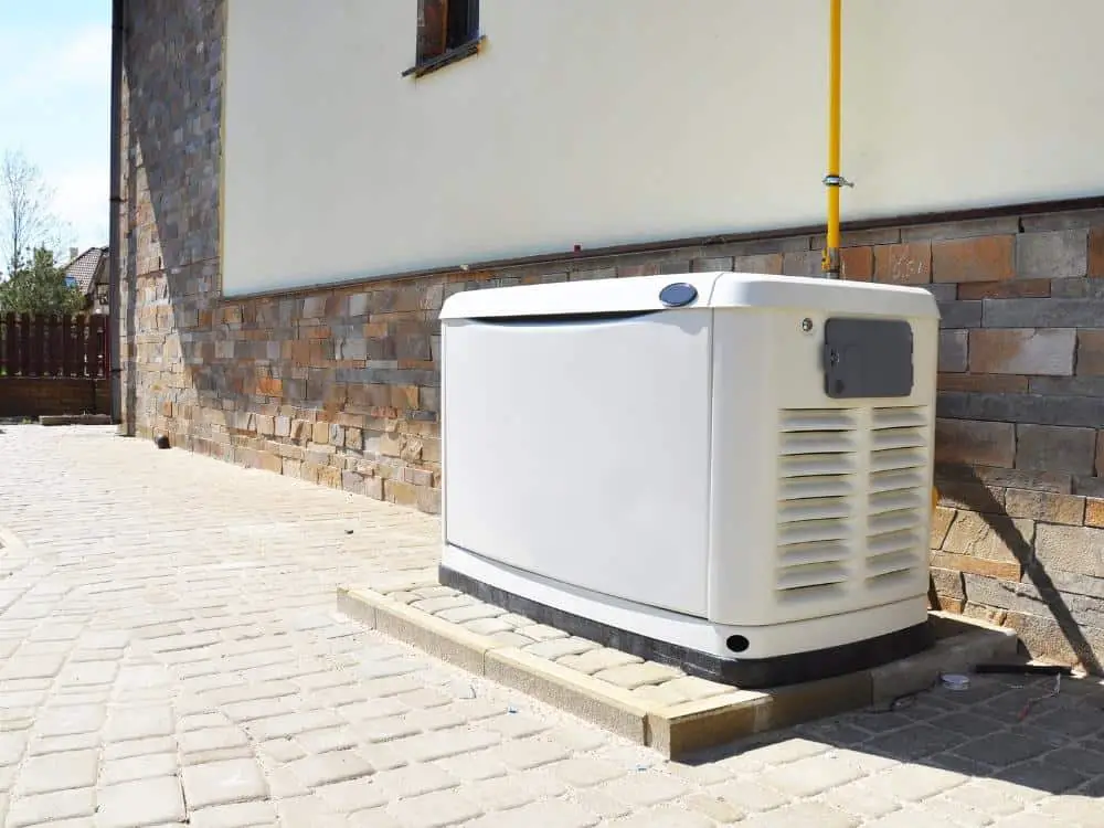 Generator in a yard next to a house